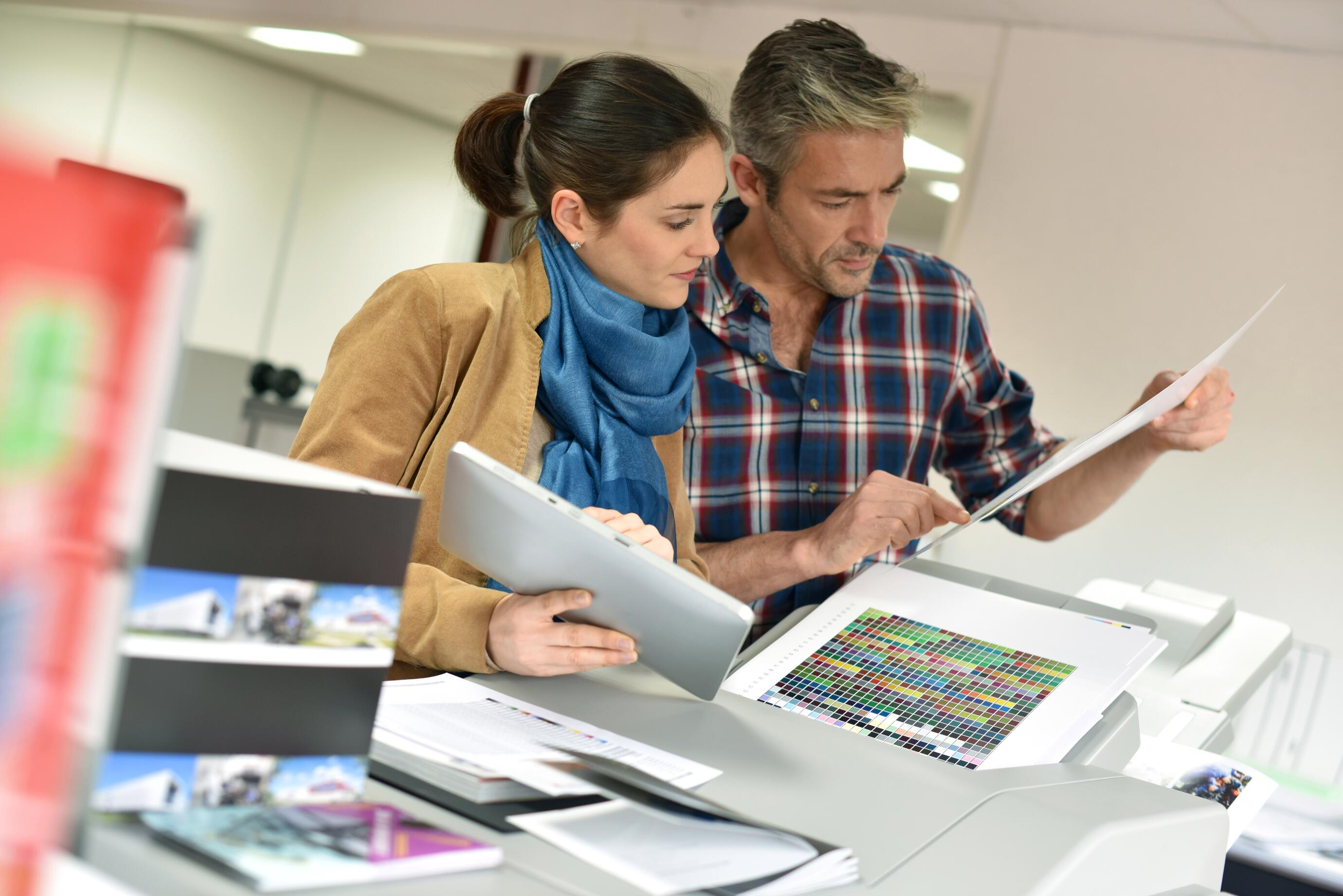 Client in printshop controlling work before final printing